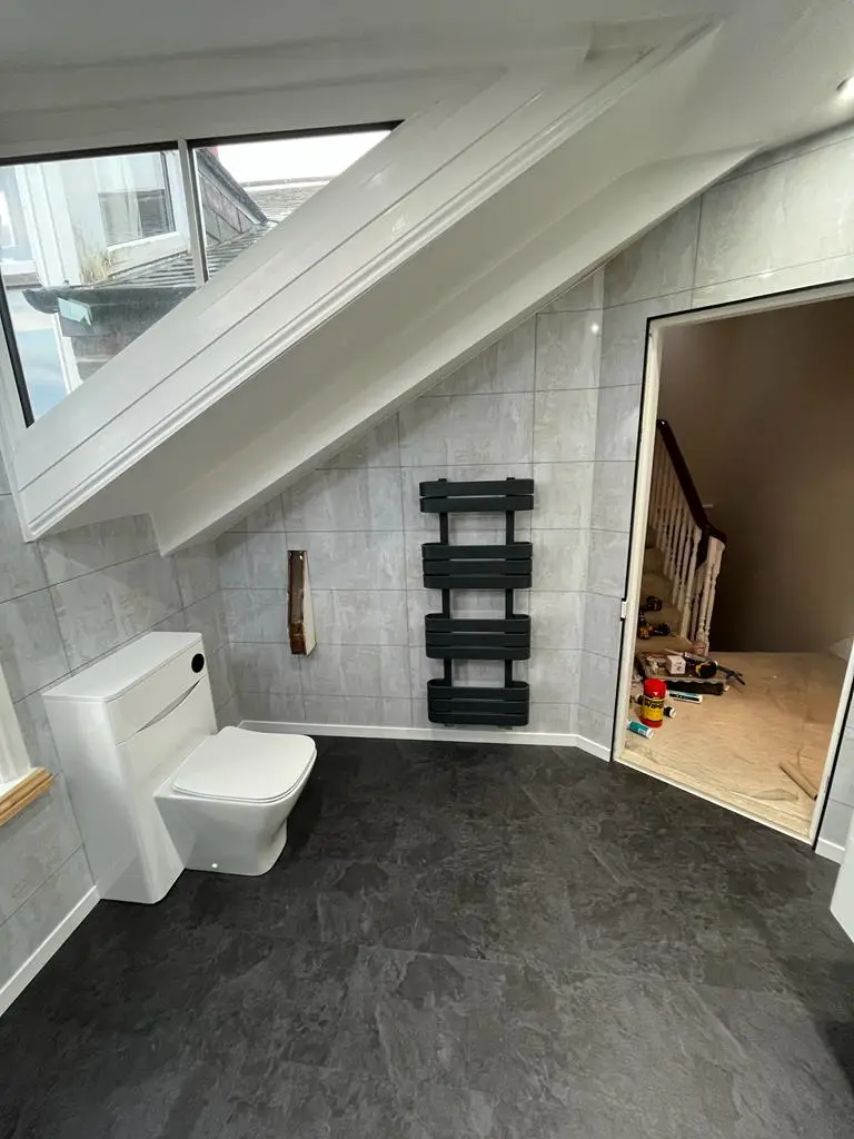 Dormer window with oak sill, anthracite designer towel radiator and slate-effect floor