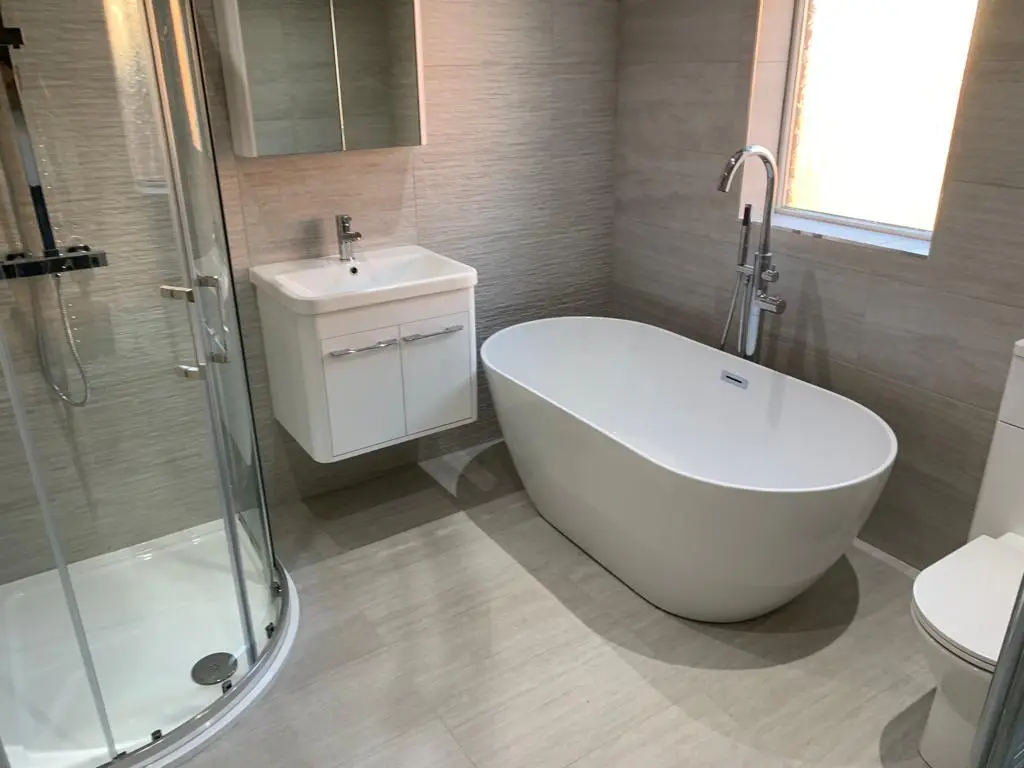 Family bathroom with freestanding bath, corner quadrant shower and wall-hung vanity