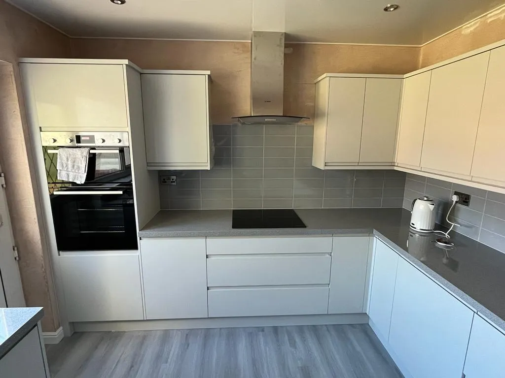Kitchen refit underway: white handleless units, grey metro splashback and hob fitted