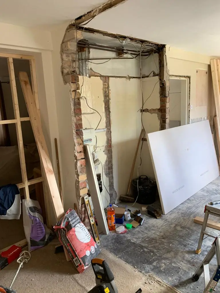 Structural opening knocked through with exposed brick and new steel lintel